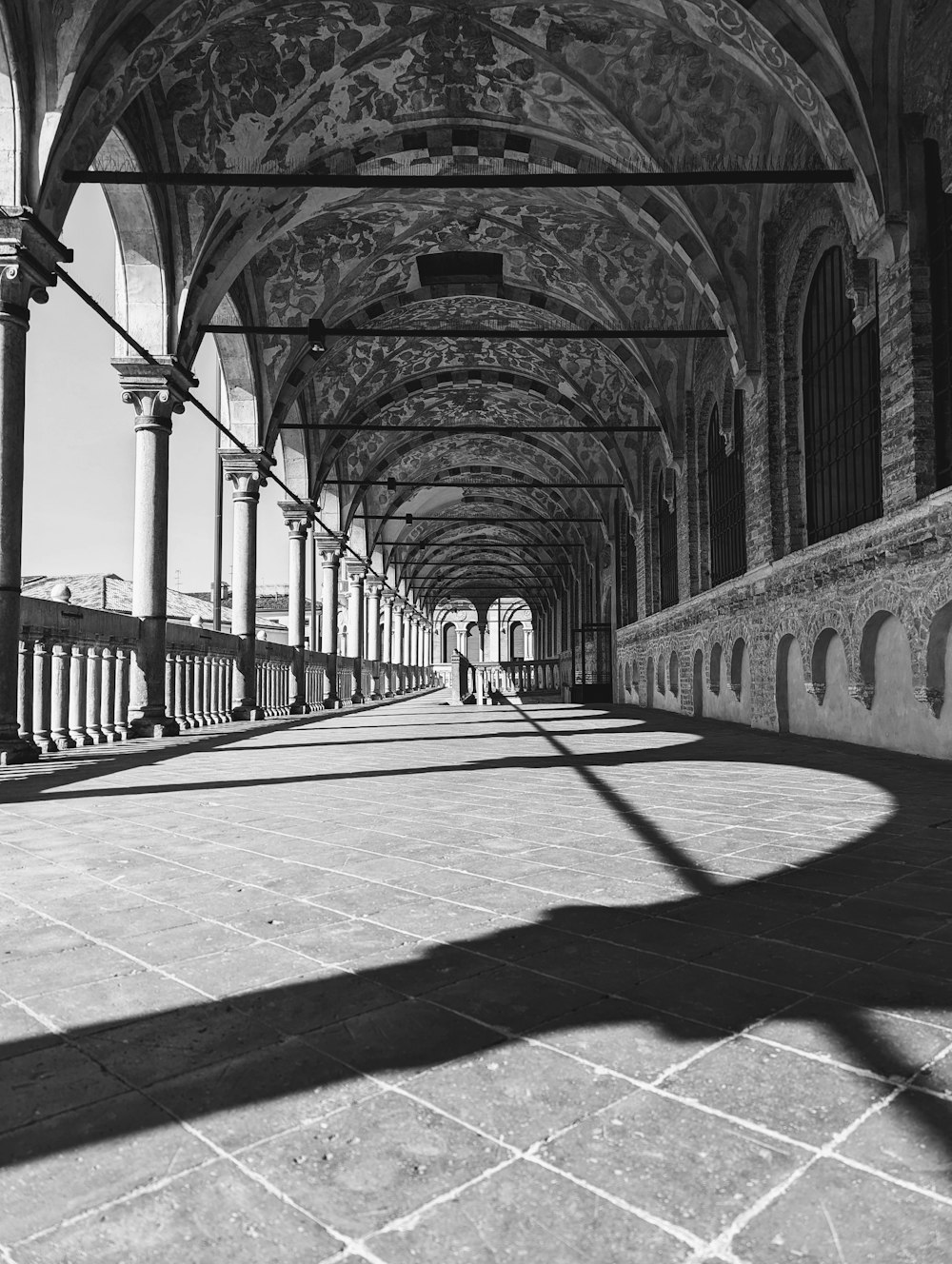 a black and white photo of a walkway