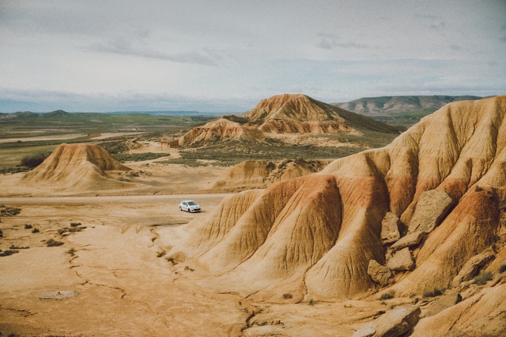 a car is parked in the middle of the desert