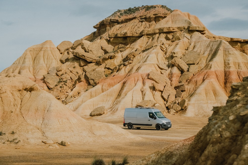 a van is parked in front of a mountain