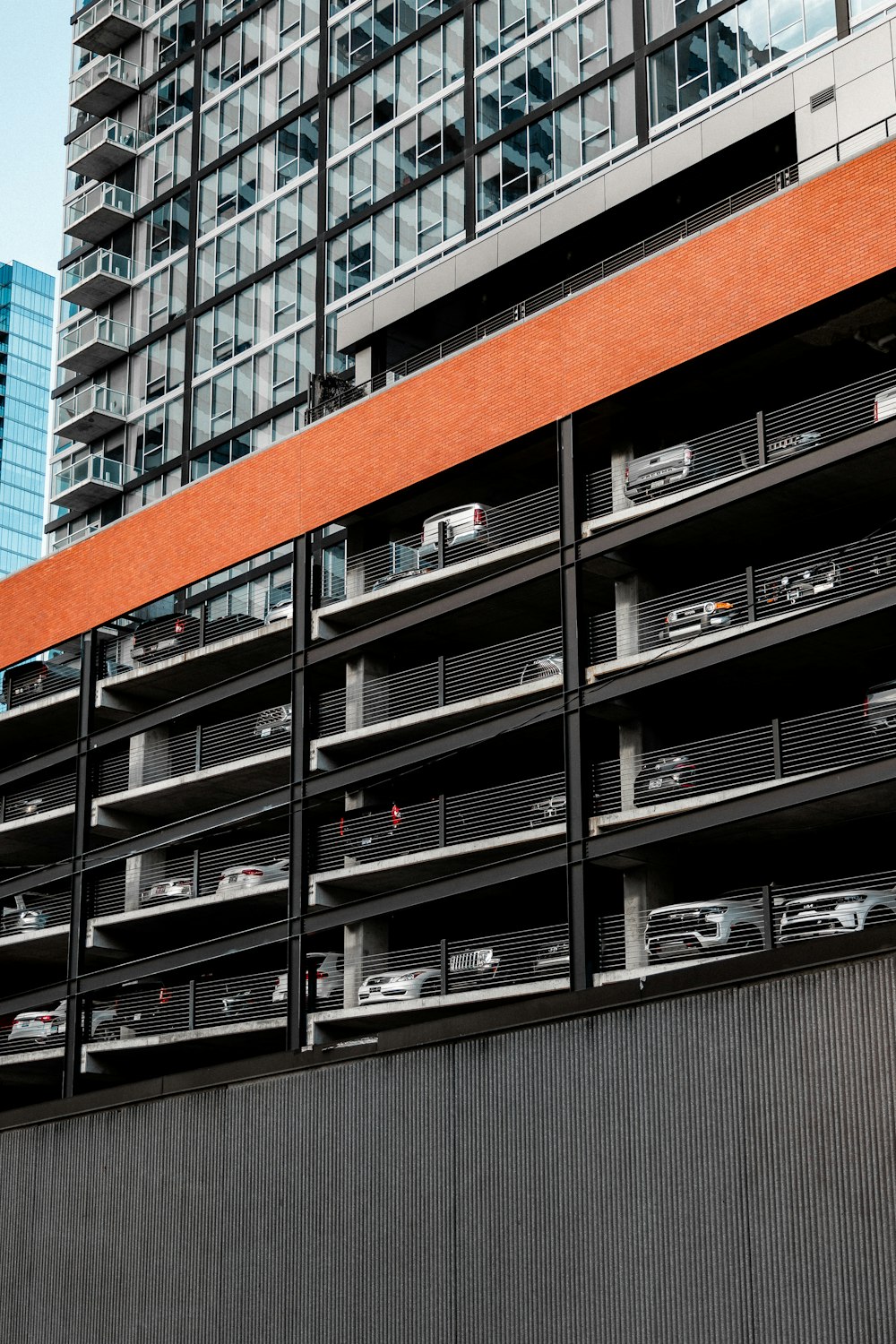 a tall building with lots of cars parked in front of it