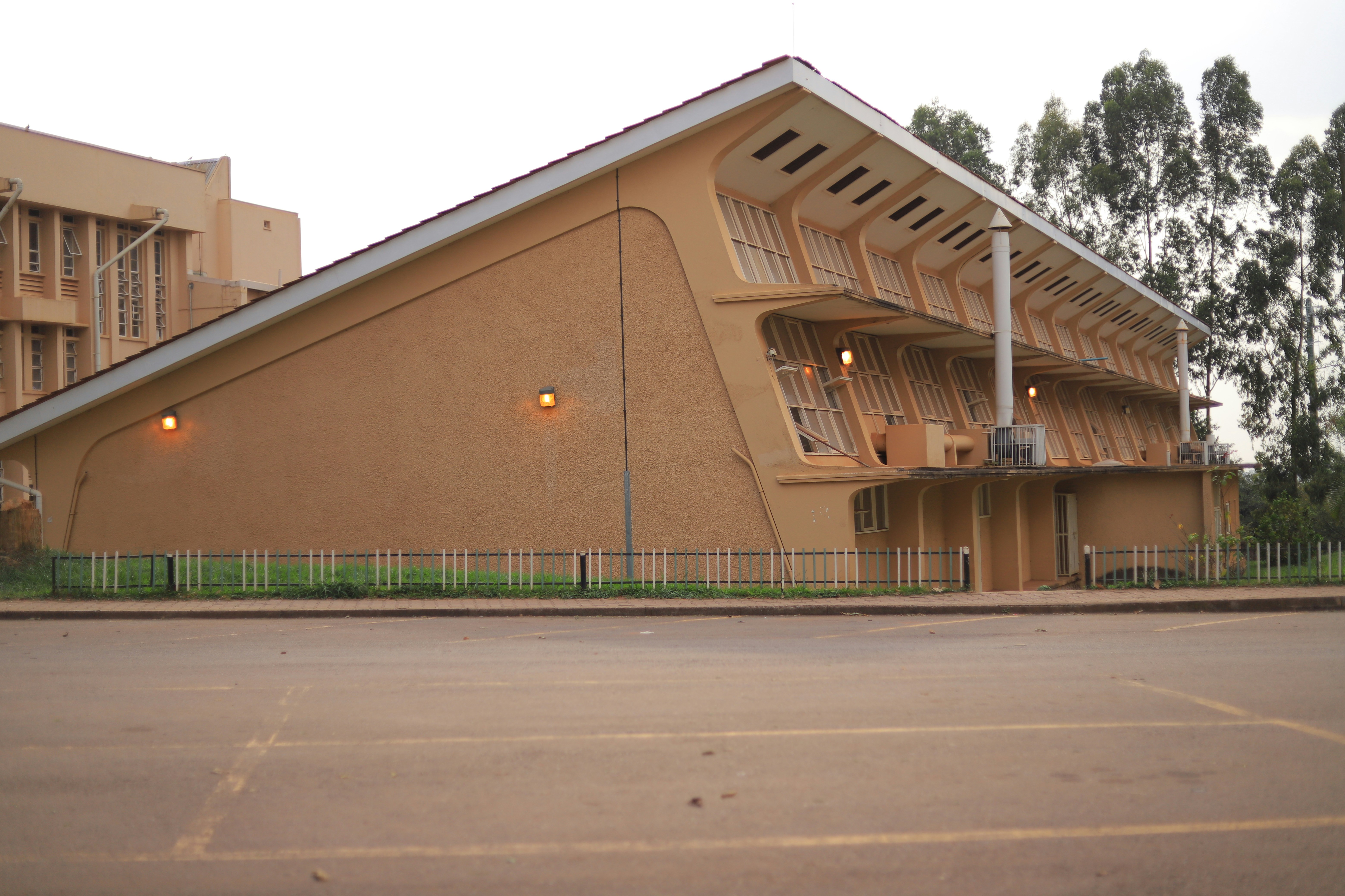 a tan building with a metal fence around it