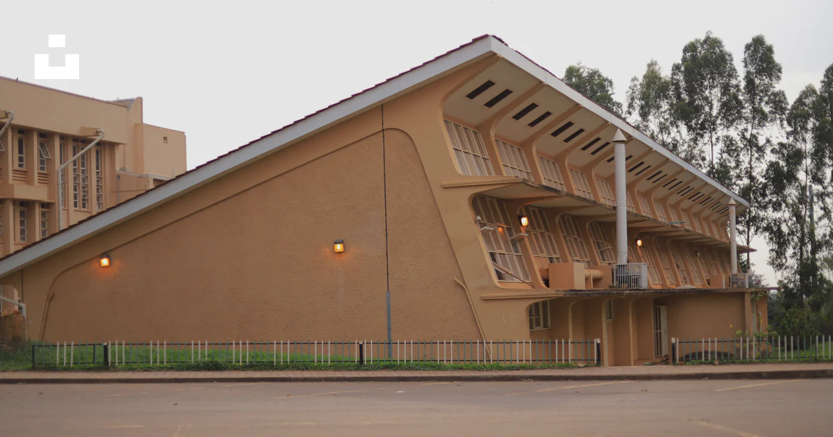 Tan Building A tan building with a metal fence around it photo – Free City Image on ...