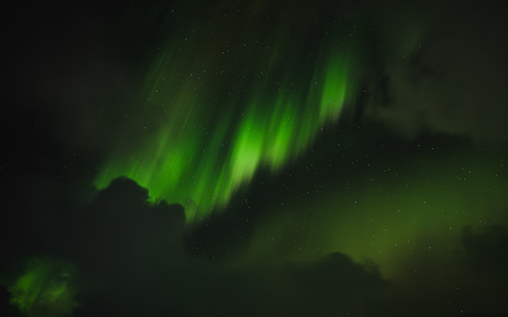 a bright green aurora bore in the night sky