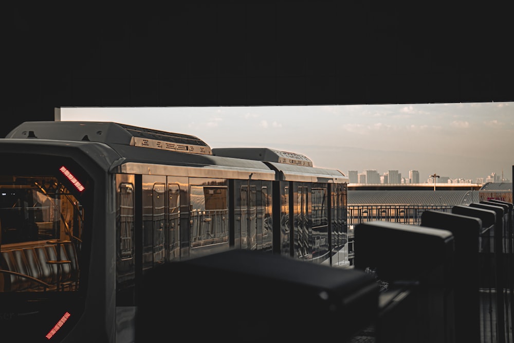 a train traveling down train tracks next to a train station