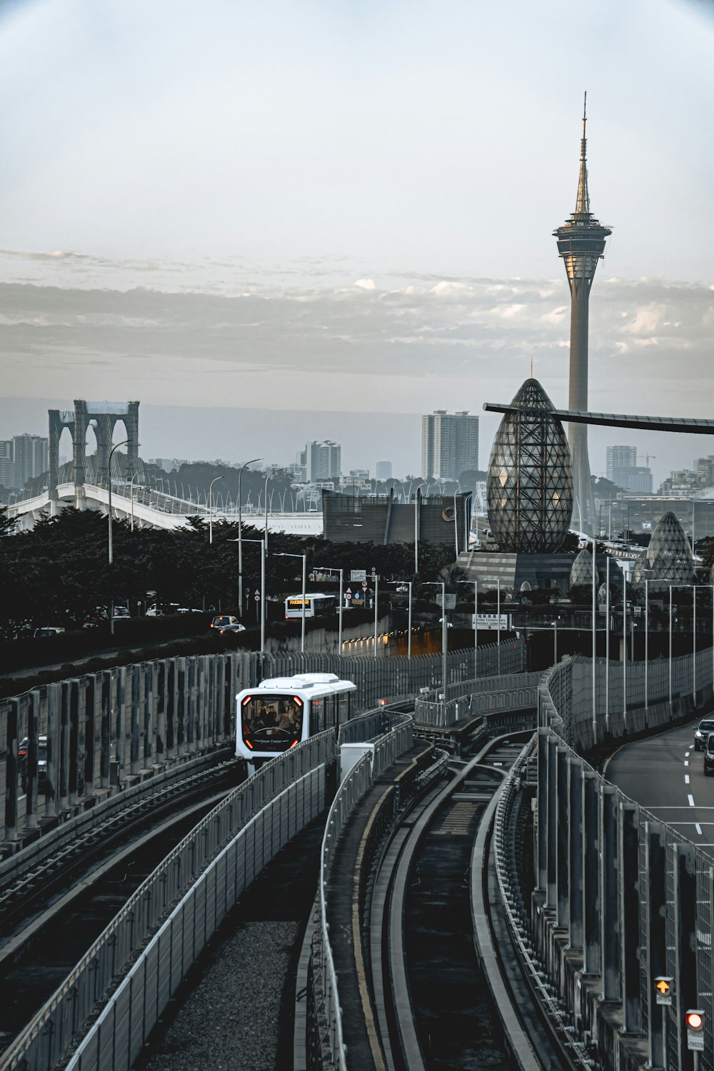 a train traveling down train tracks next to a tall building