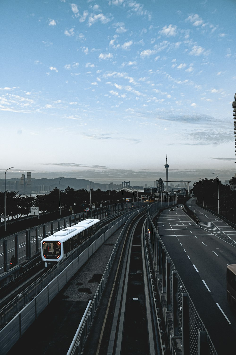 a train traveling down a train track next to a tall building