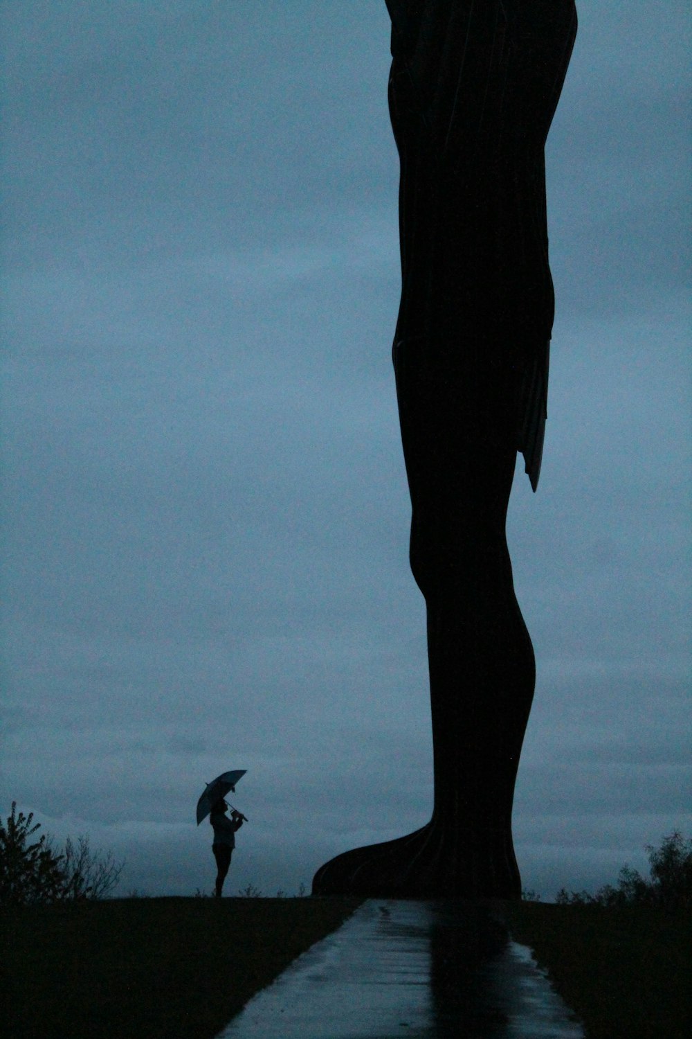 a silhouette of a person holding an umbrella