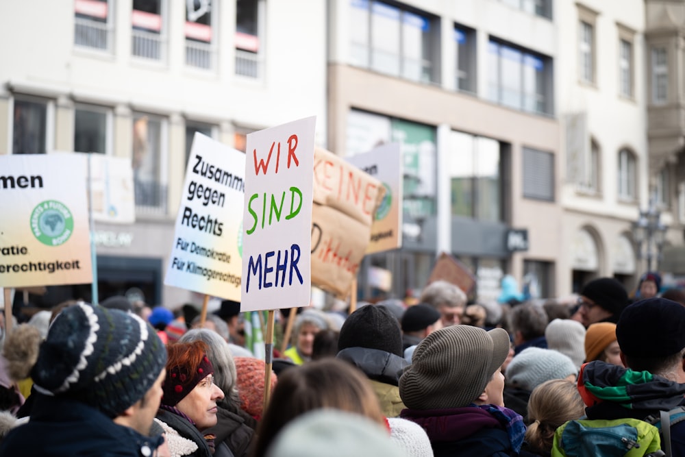 a crowd of people holding signs in the street