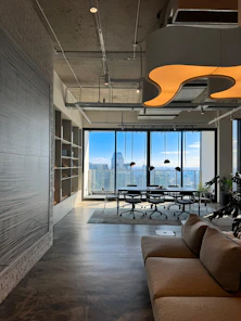 a living room filled with furniture and a large window