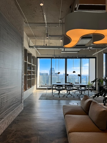 a living room filled with furniture and a large window