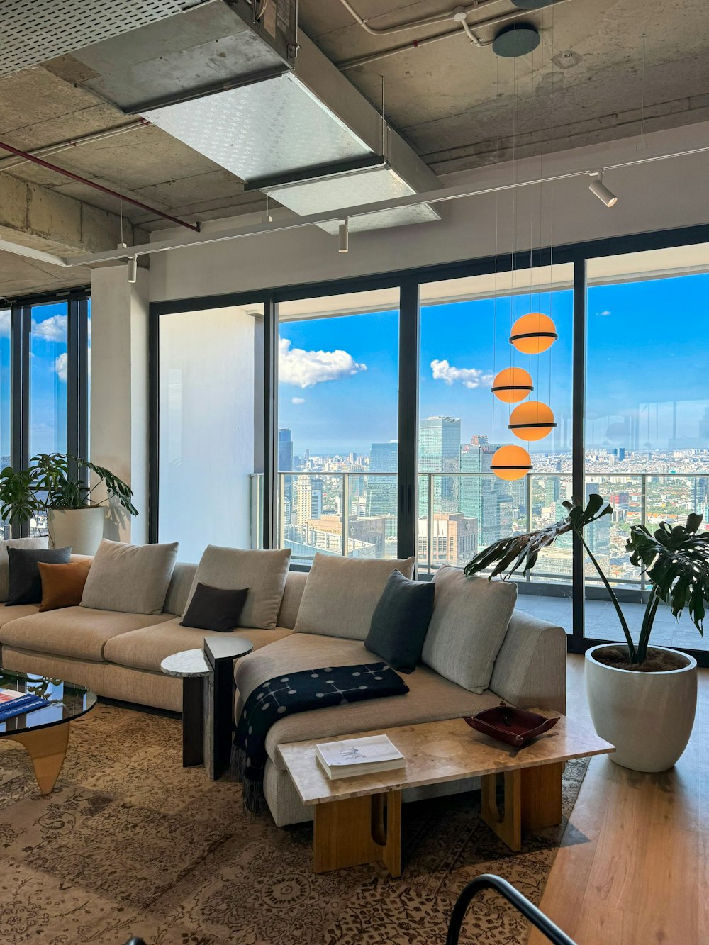 a living room filled with furniture and large windows