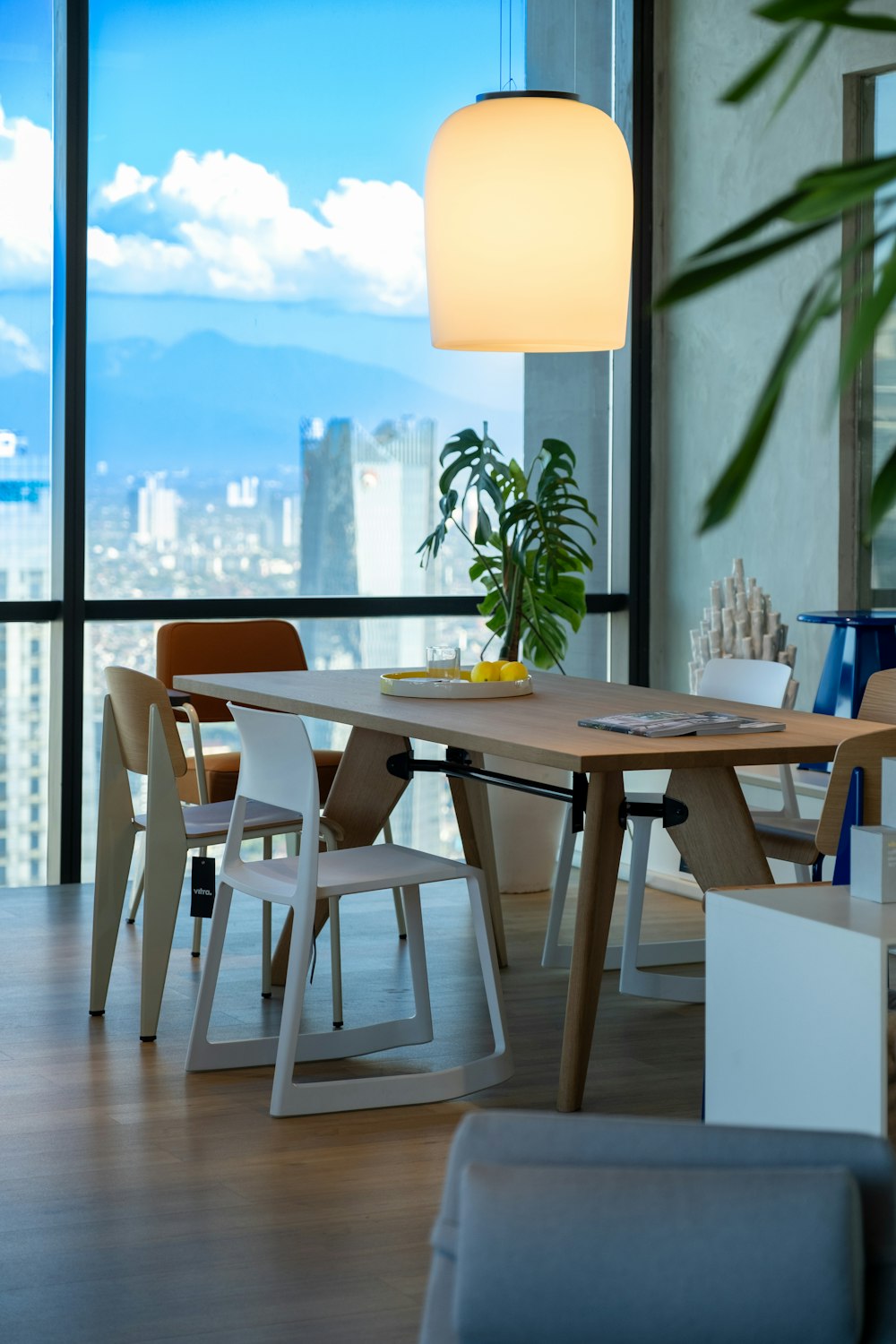 a room with a table, chairs and a large window