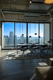 a room with a table and chairs and a view of the city
