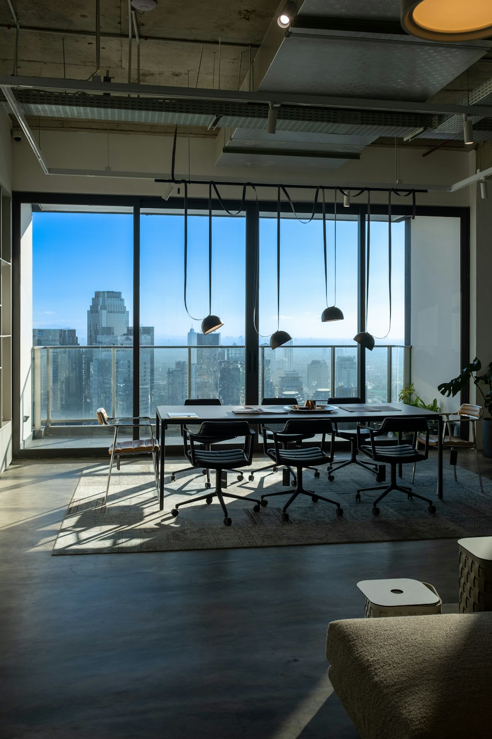 a room with a table and chairs and a view of the city