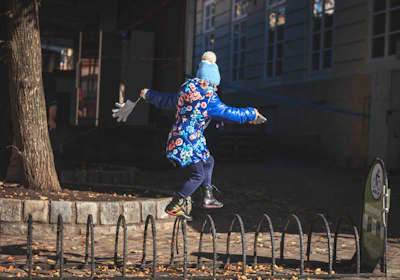 a person on a snowboard jumping over a rail