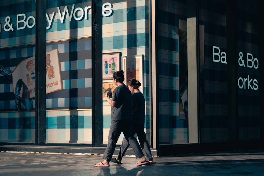 a couple of people walking down a street