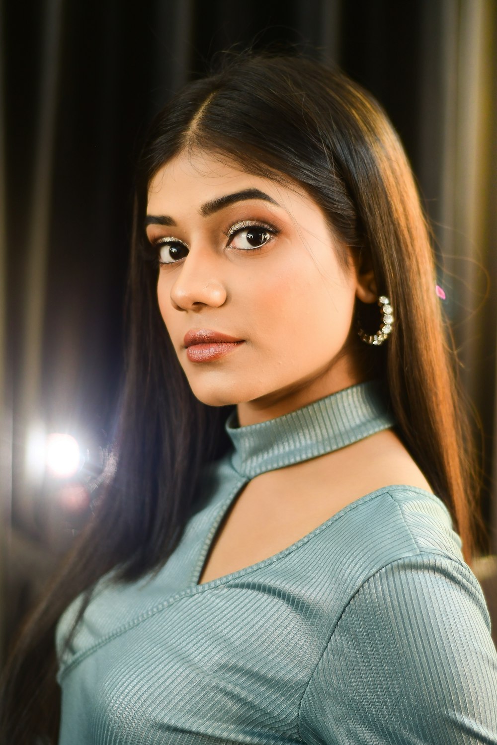 a woman with long hair wearing a blue shirt