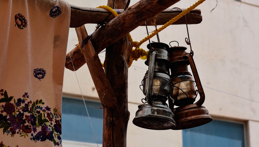 a group of bells hanging from a wooden pole