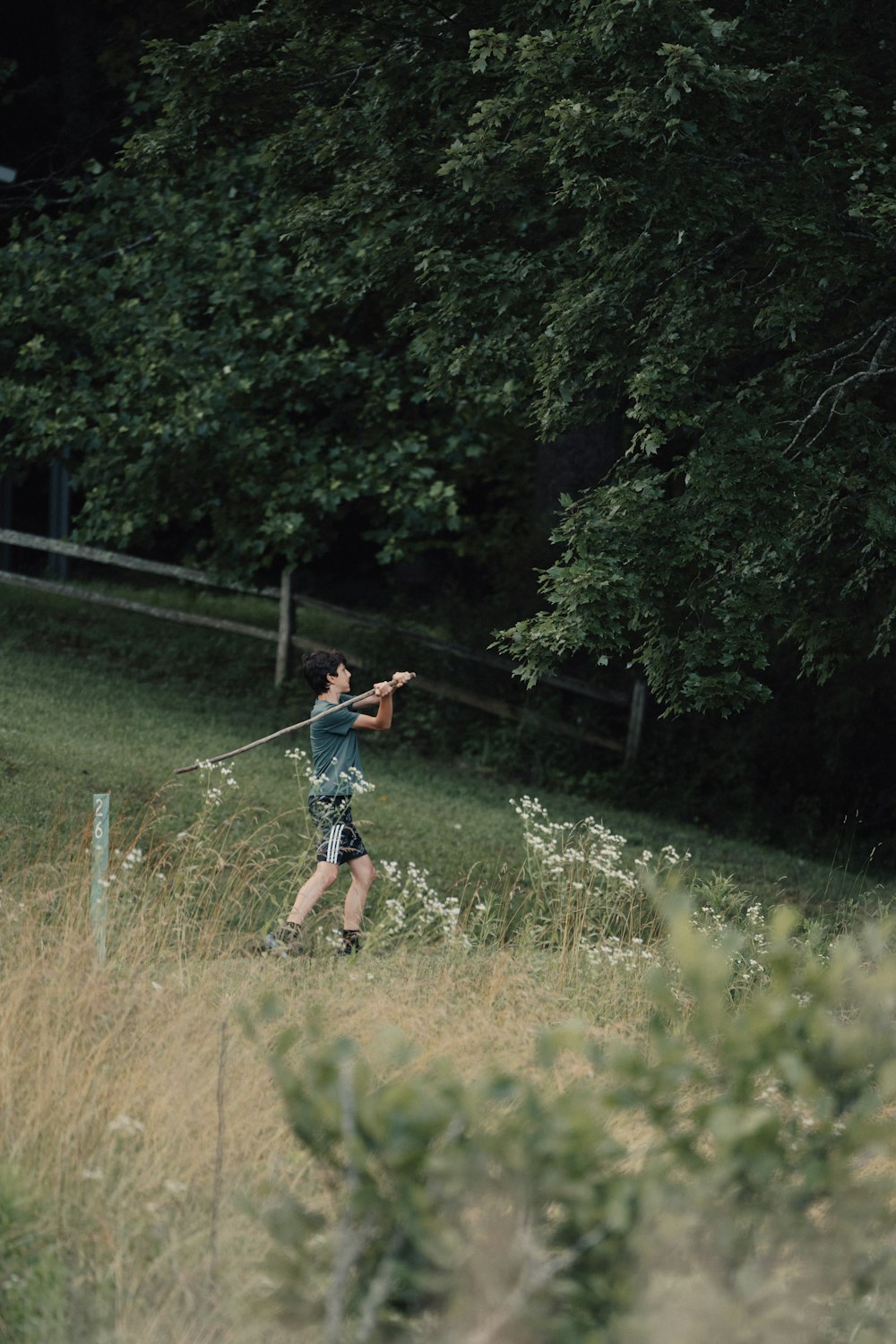a person in a field with a baseball bat