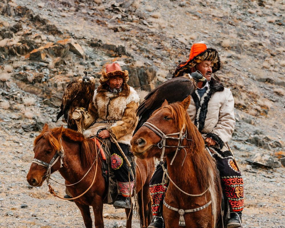 a couple of people riding on the back of horses