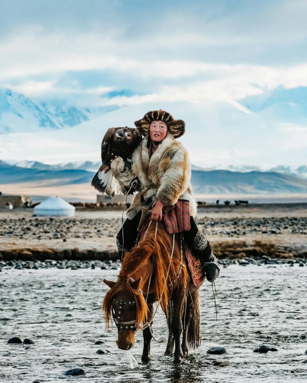 a man on a horse with an eagle on his back