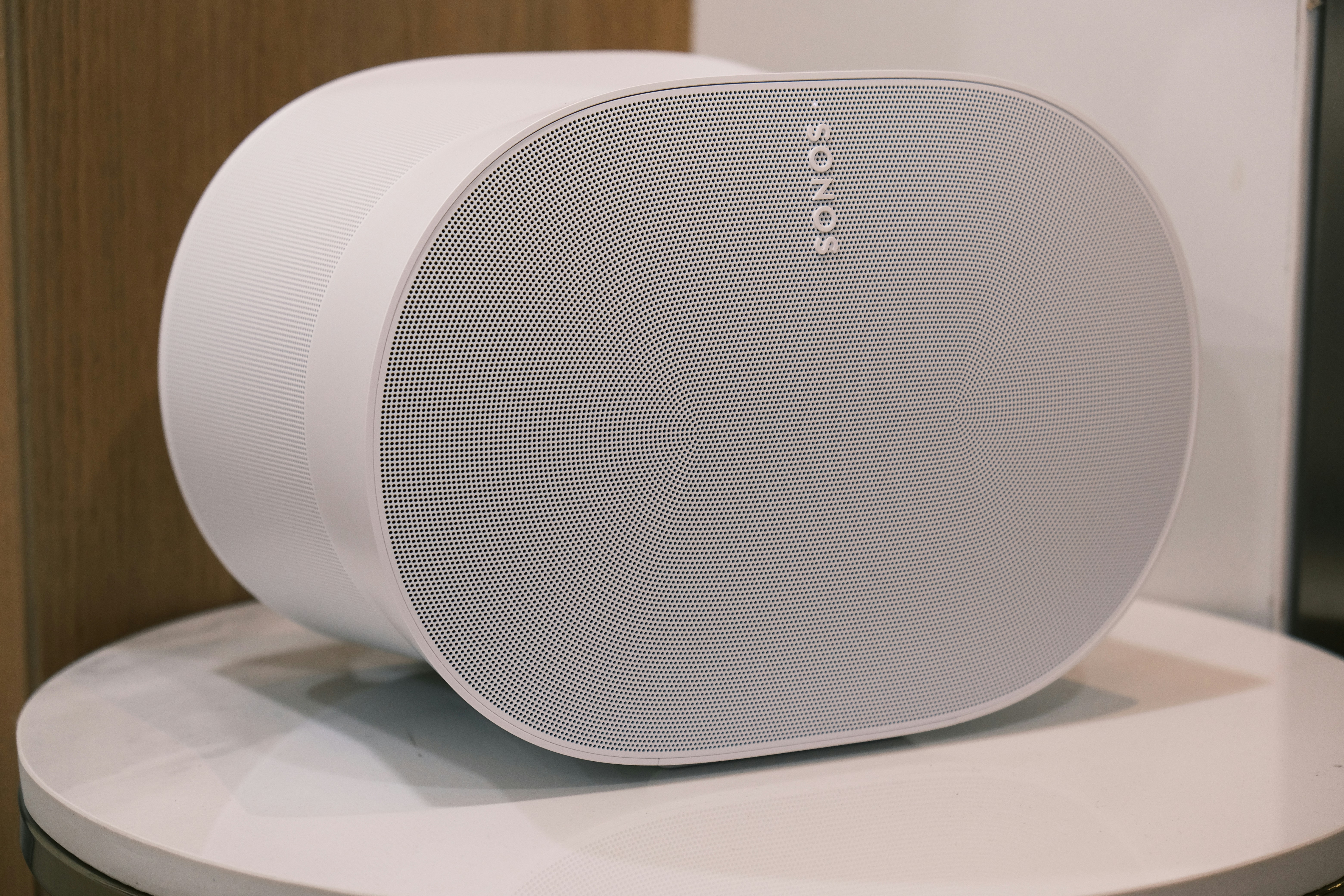 a white speaker sitting on top of a table