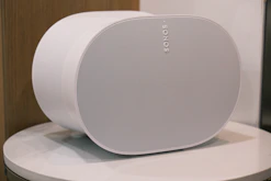 a white speaker sitting on top of a table