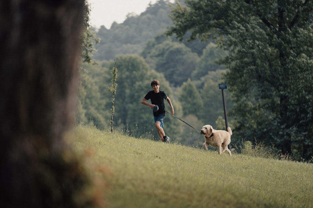 a man running with a dog on a leash