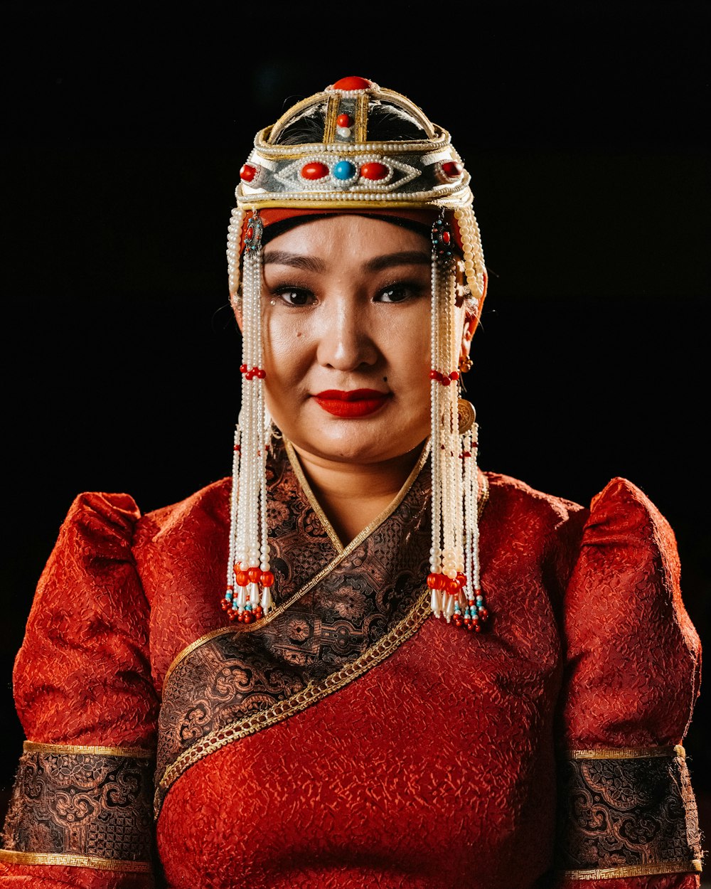 a woman in a red dress and headdress