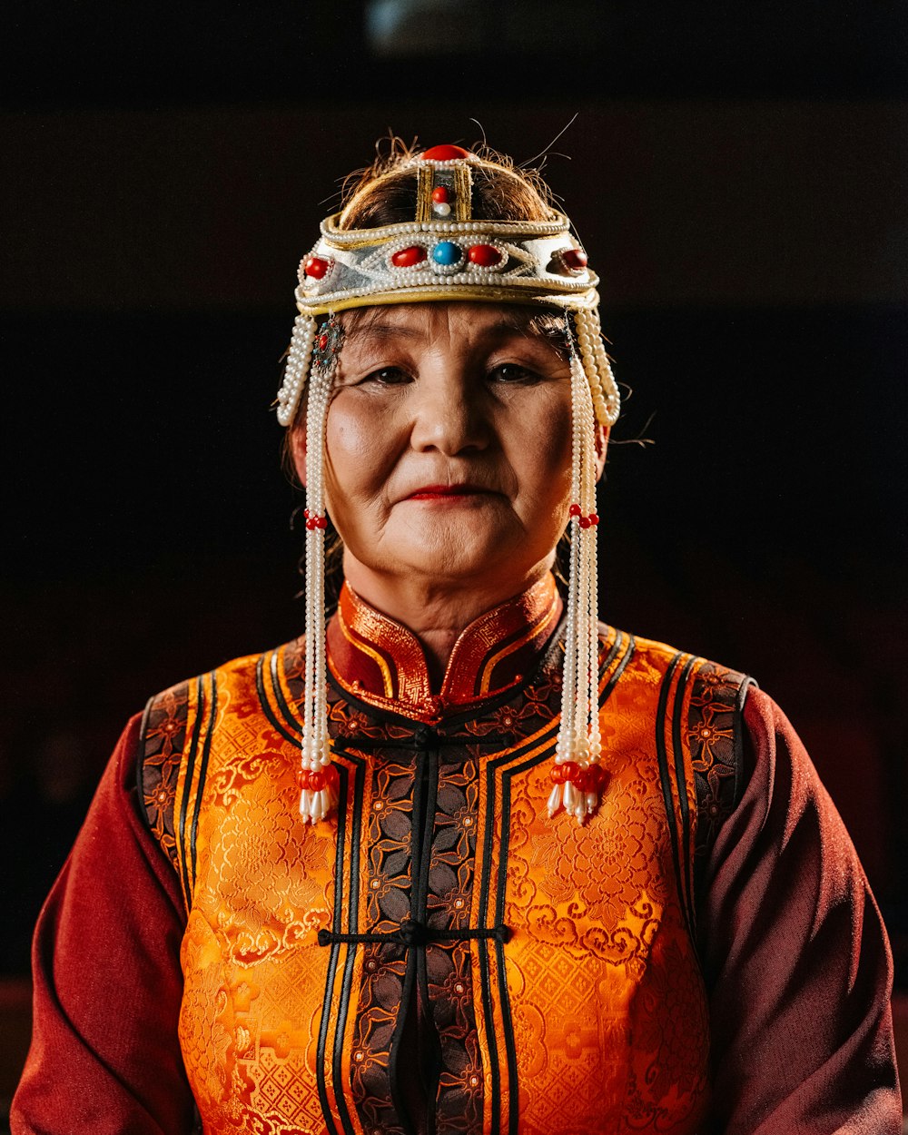 an old woman wearing a headdress and a necklace