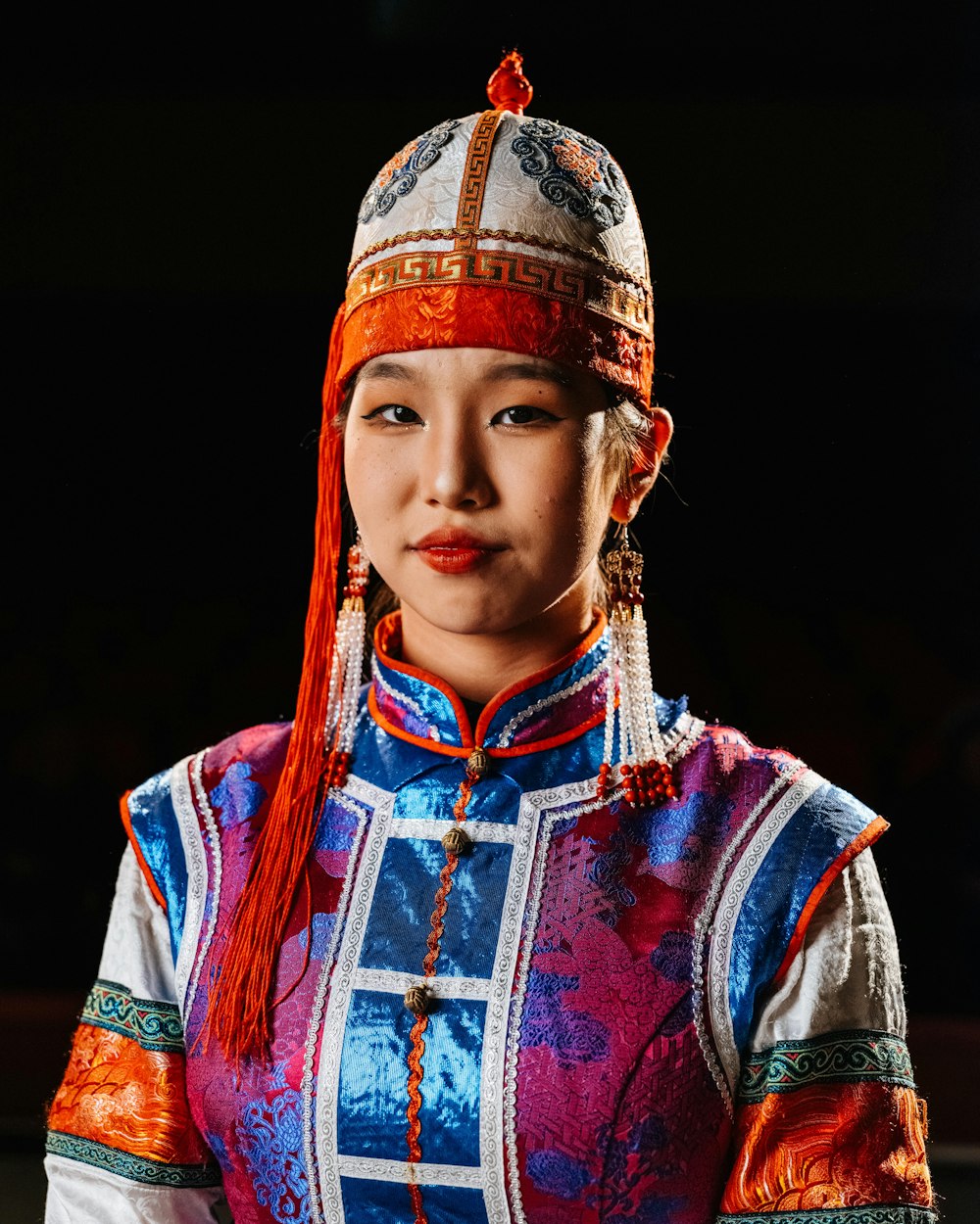a woman wearing a colorful dress and a hat