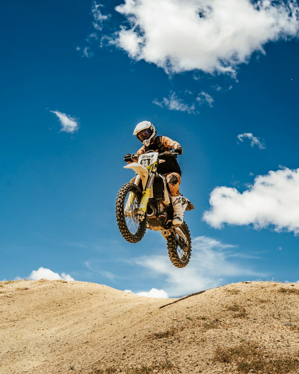 a man riding a dirt bike through the air