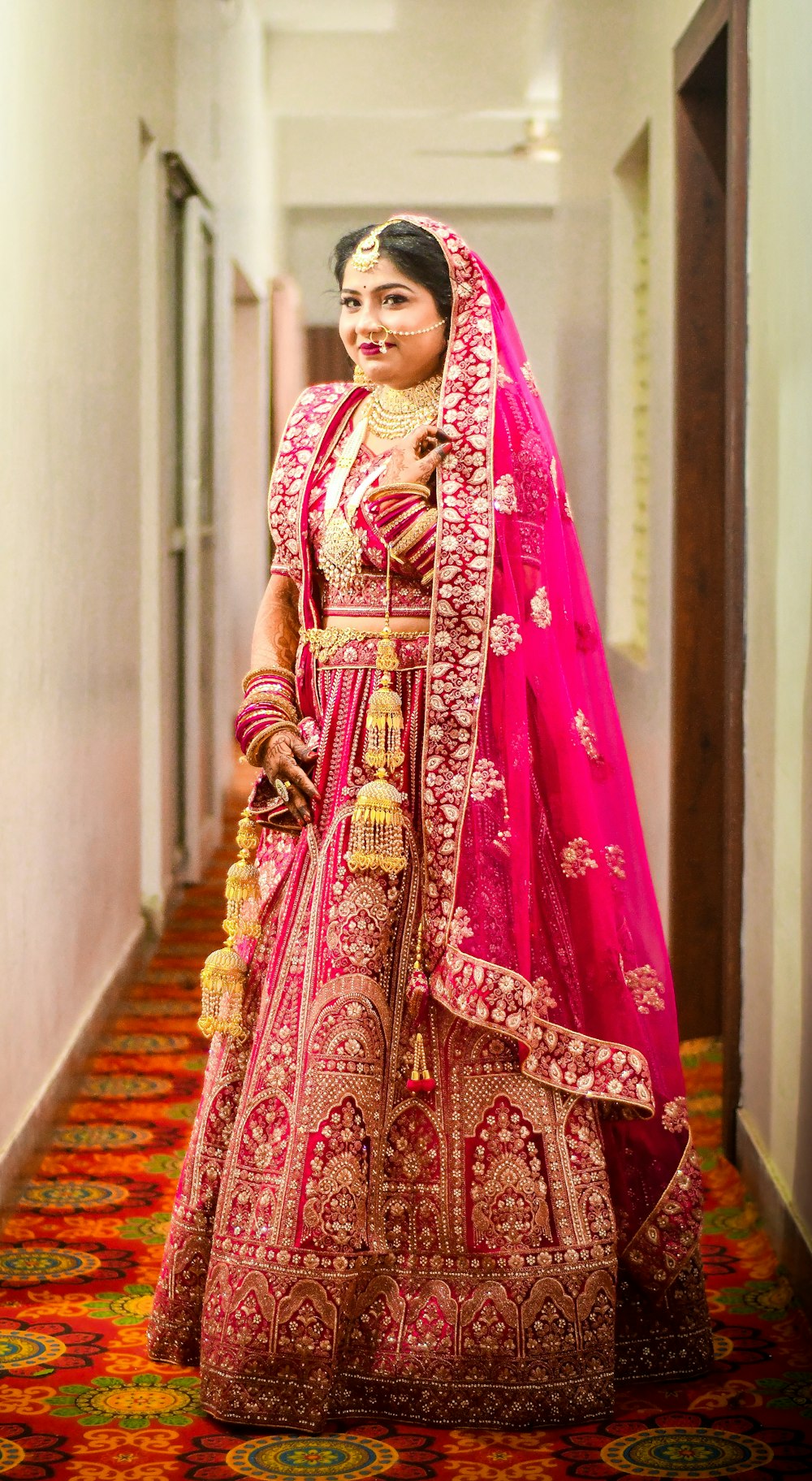 a woman in a red and gold bridal gown