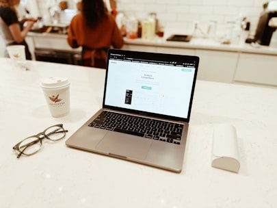 a laptop computer sitting on top of a white counter