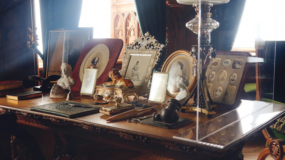 a table topped with pictures and a lamp