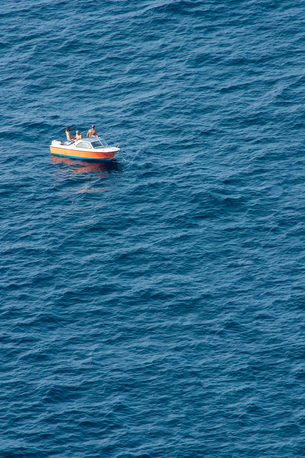 a small boat floating on top of a large body of water