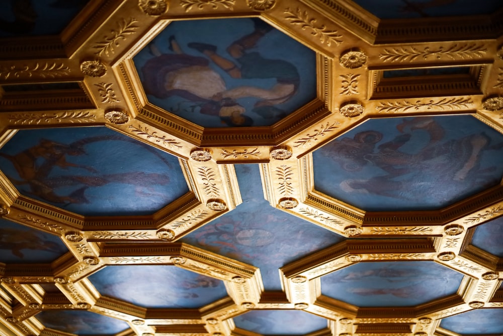 a close up of a ceiling with paintings on it