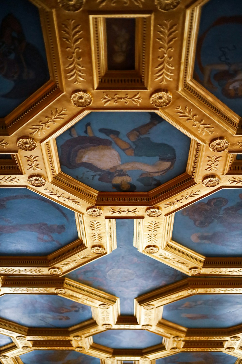 the ceiling of a building with paintings on it