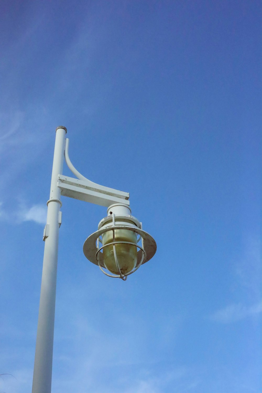 a street light with a blue sky in the background