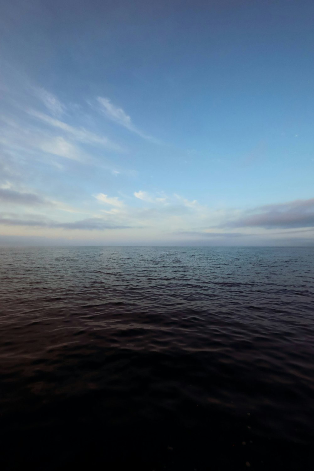 a large body of water under a blue sky