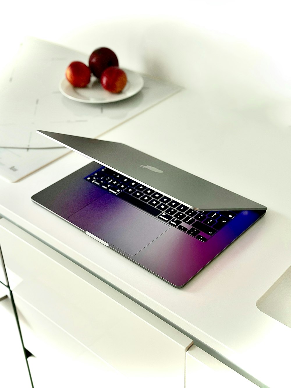 a laptop computer sitting on top of a white table