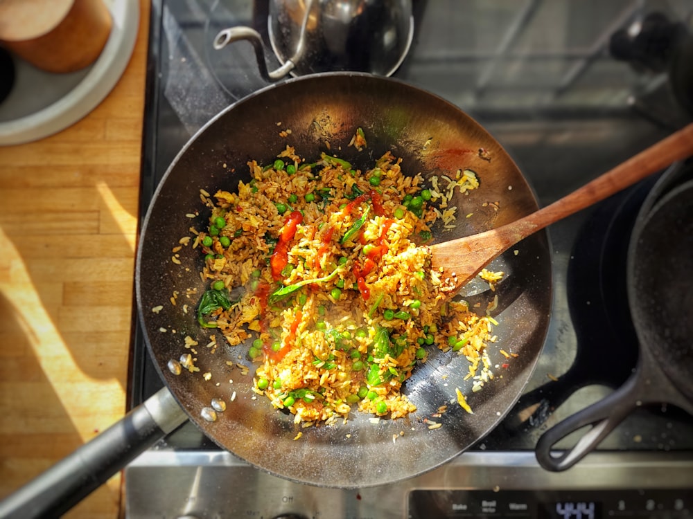 a frying pan filled with food on top of a stove