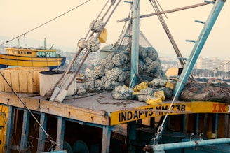 a yellow and blue boat with lots of stuff on it
