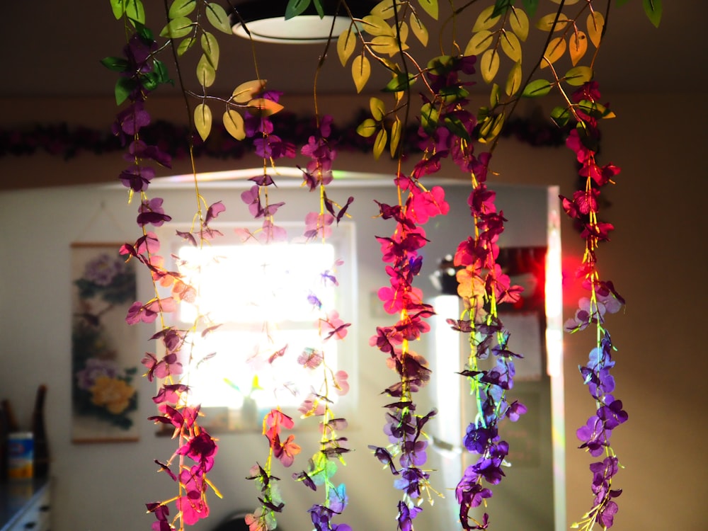 a bunch of flowers that are hanging from a ceiling