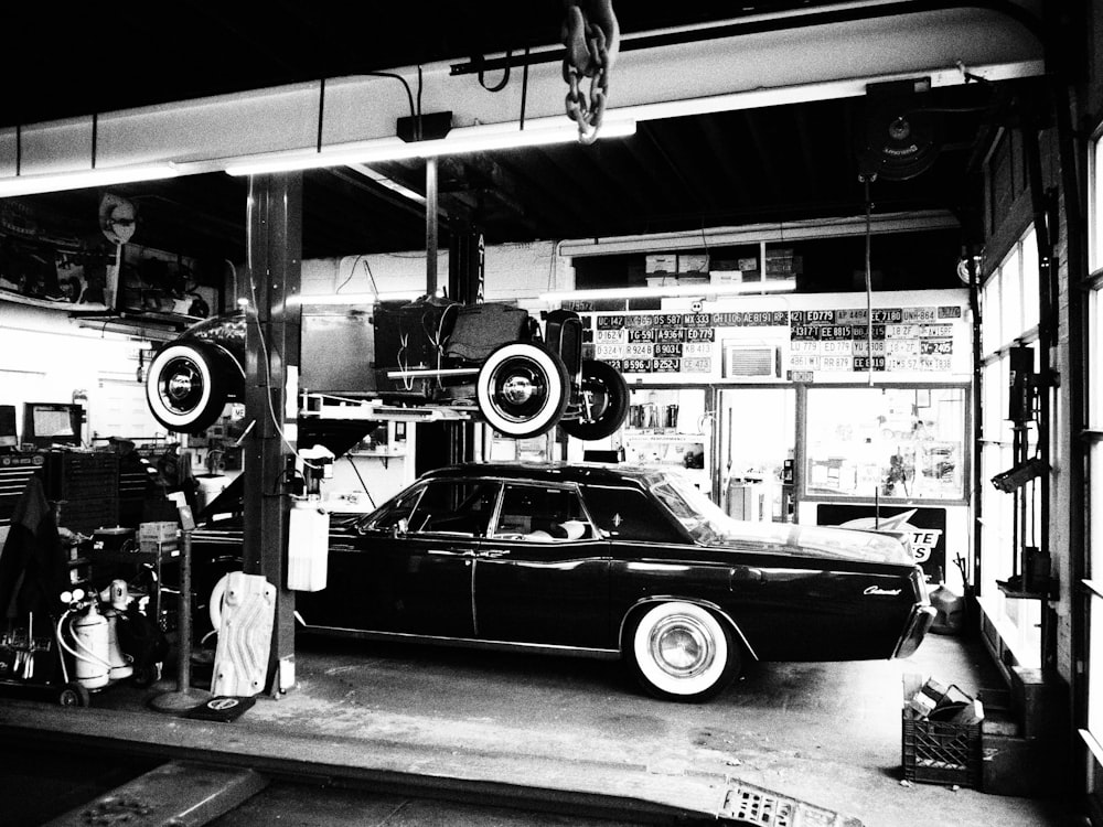 a black and white photo of a car in a garage