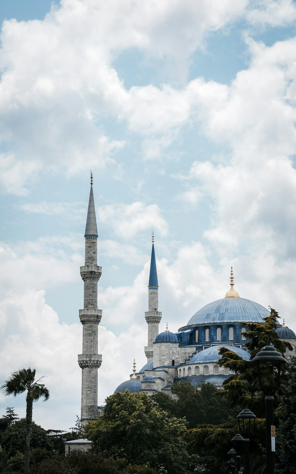 a large blue and white building with a sky background