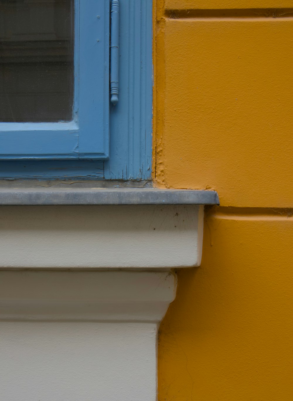 a close up of a window on a yellow building