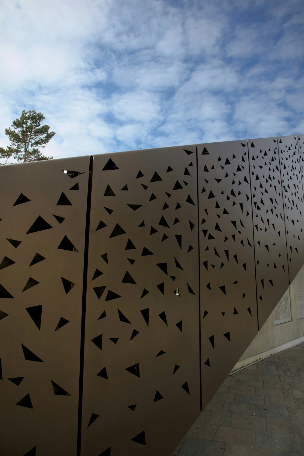 a large metal wall with black triangles on it