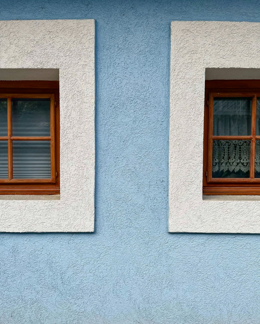 a couple of windows sitting on the side of a building