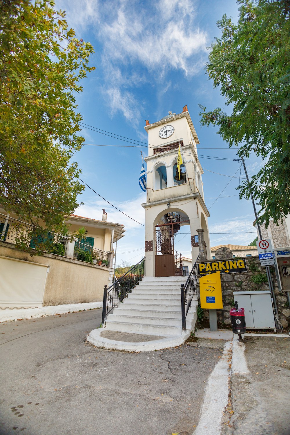 a clock tower sitting on the side of a road